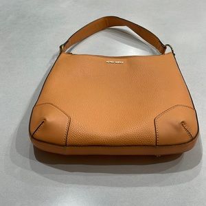 Nine West purse in a orange sherbet color. Detachable cross-body shoulder strap.